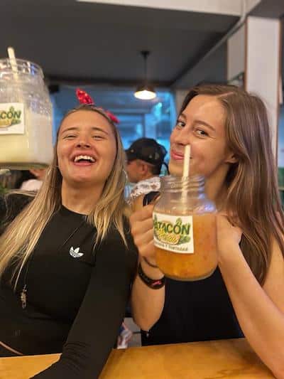 Giselle and her friend looking happy with fruit smoothies in Patacón, a restaurant in Cali