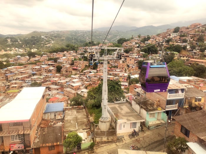 A purple cable car over Siloe and La Estrella neighbourhoods. This is one of the best things to do in Cali, Colombia