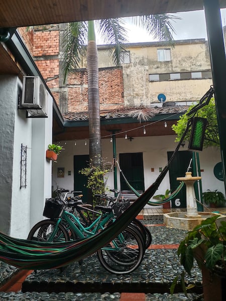 Hammocks, a bicycle and a palm tree in Hostal Viejero's open air courtyard